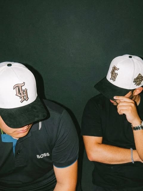 Dos clientes usando gorras Two Hatters